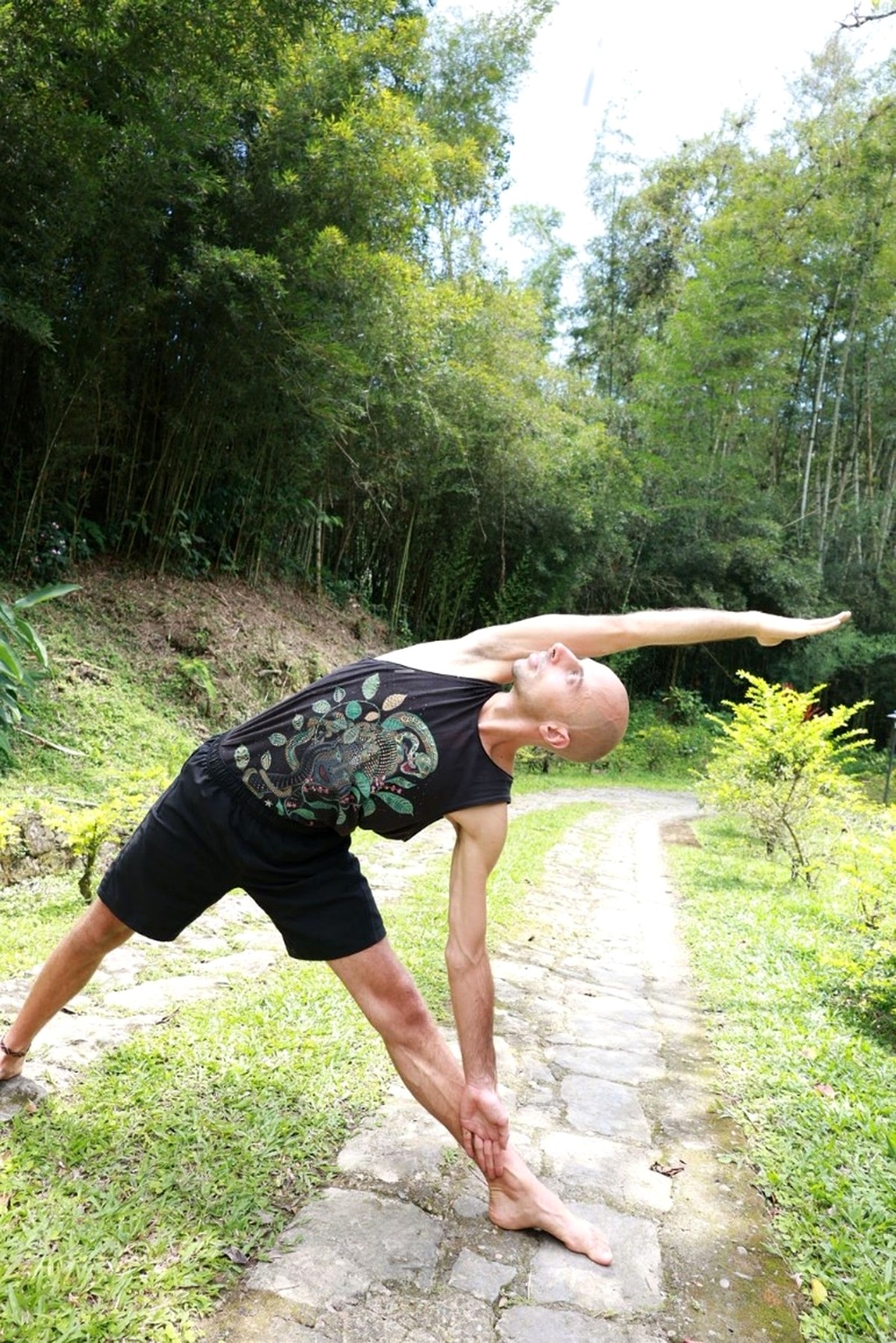 Dominik Wagner in a triangle pose outdoors